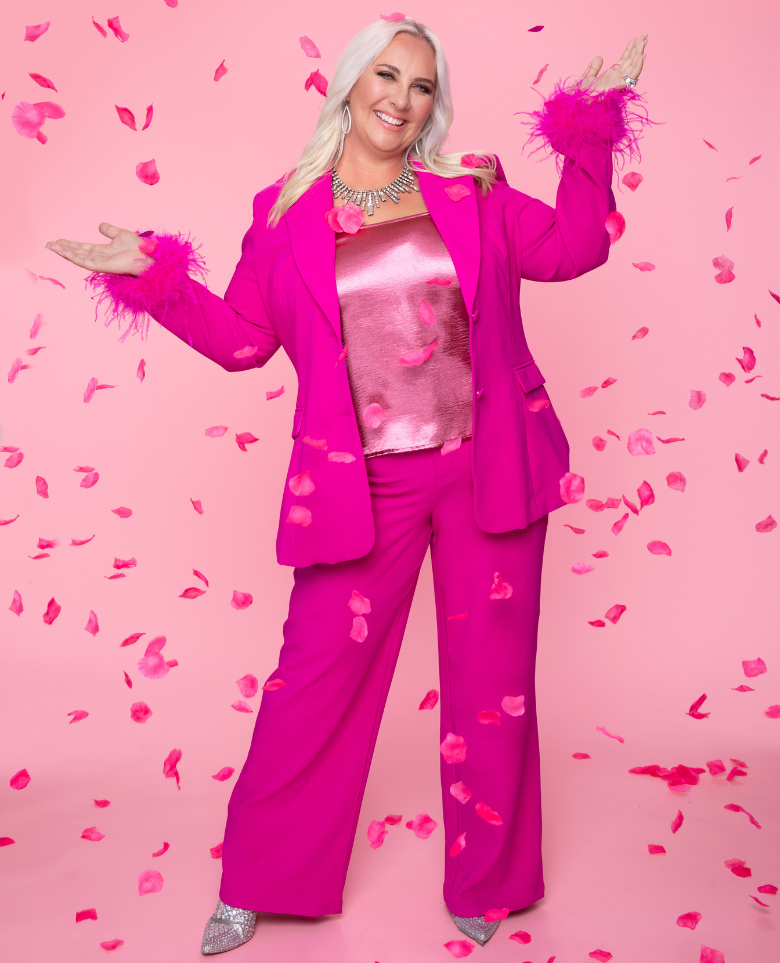 Julie Pink suit on Pink background with flowers falling